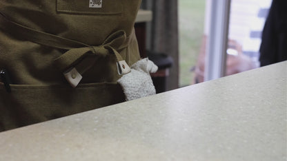 video of barista pouring maple syrup into the bottom of a circle-shaped glass cup.